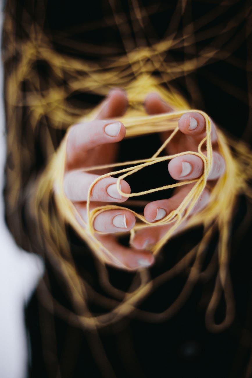 close up of woman hands tangled with string