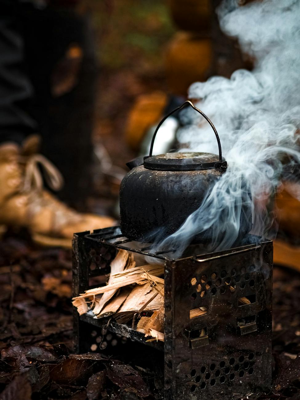 close up of cauldron boiling on campfire